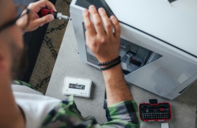 Person Sits At A Bright, Minimalist Desk, Using A Calculator Next To A Notebook And A Set Of House Keys, Representing The ...