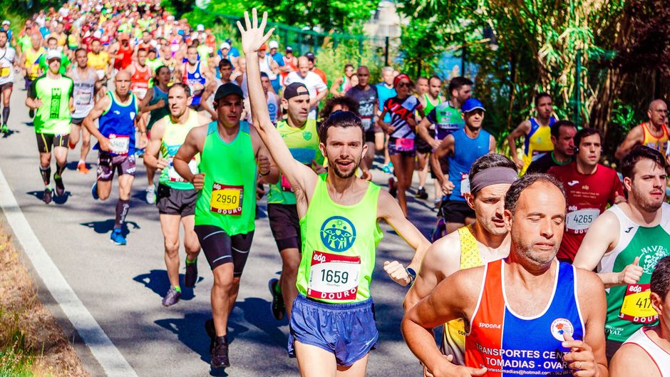 A lone runner on a long, winding road through a scenic landscape, illustrating the endurance and long-term strategy of an SEO retainer model.