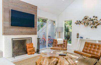 Person Using A Laptop In A Bright, Modern Vacation Rental, Illustrating The Ease Of Managing A Direct Booking Website.